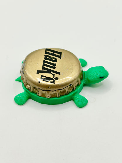 Hank’s Gourmet Beverages (Gold) - Bottle Cap Magnet Turtle Shell Shocked Art