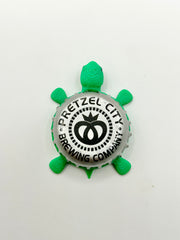 Pretzel City Brewing - Bottle Cap Magnet Turtle Shell Shocked Art