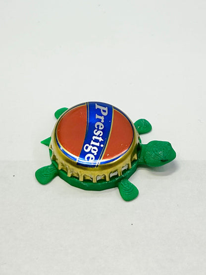 Prestige Beer - Bottle Cap Magnet Turtle Shell Shocked Art